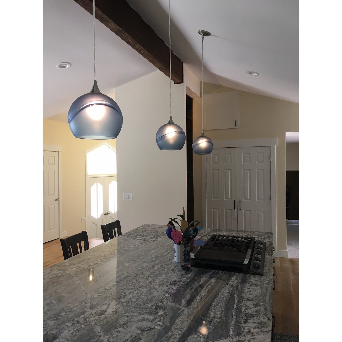 Bicycle Glass Co 768 Glacial: Single Pendant Light, Steel Blue Glass, Brushed Nickel Hardware, Light Bulb On, Lifestyle Shot, Kitchen Island Lighting, 3 Pendant Lights Over a Kitchen Island