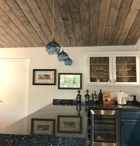 Bicycle Glass Co swell 767 single pendant lights in steel blue with brushed nickel hardware over a bar