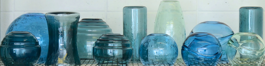 Photo of glassblower papering a starter bubble